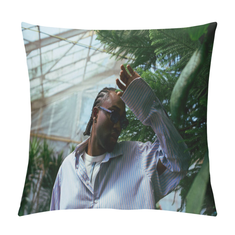 Personality  A Stylish African American Man Stands In A Greenhouse, Holding His Hand To His Head. Pillow Covers