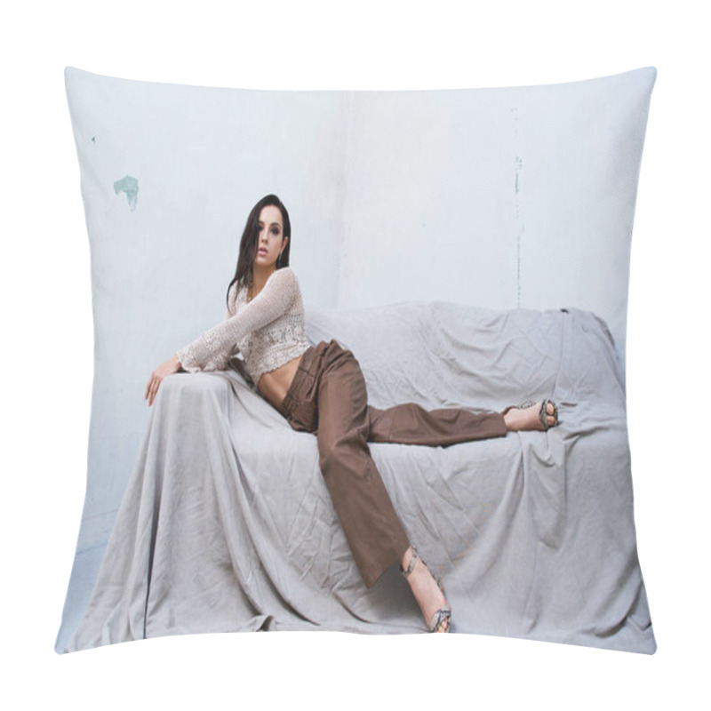 Personality  A Young Woman In A White Knitted Top And Brown Pants Poses On A Couch. Pillow Covers