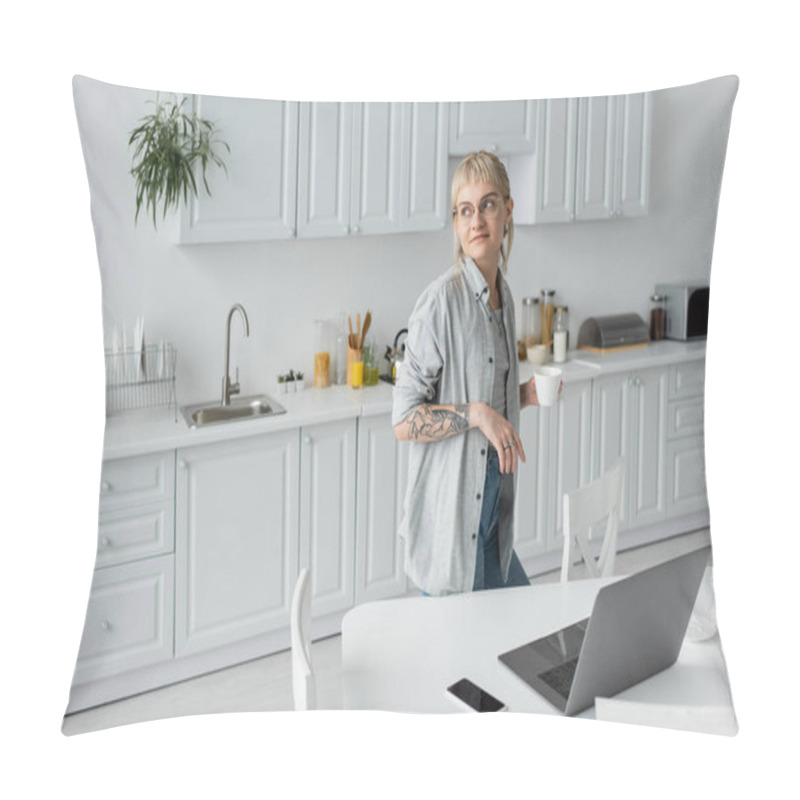 Personality  Young Woman With Tattoo On Hand And Bangs Holding Cup Of Coffee And Looking Away While Standing In Modern Kitchen Next To Laptop, Smartphone With Blank Screen On White Table Near Chairs, Freelancer  Pillow Covers