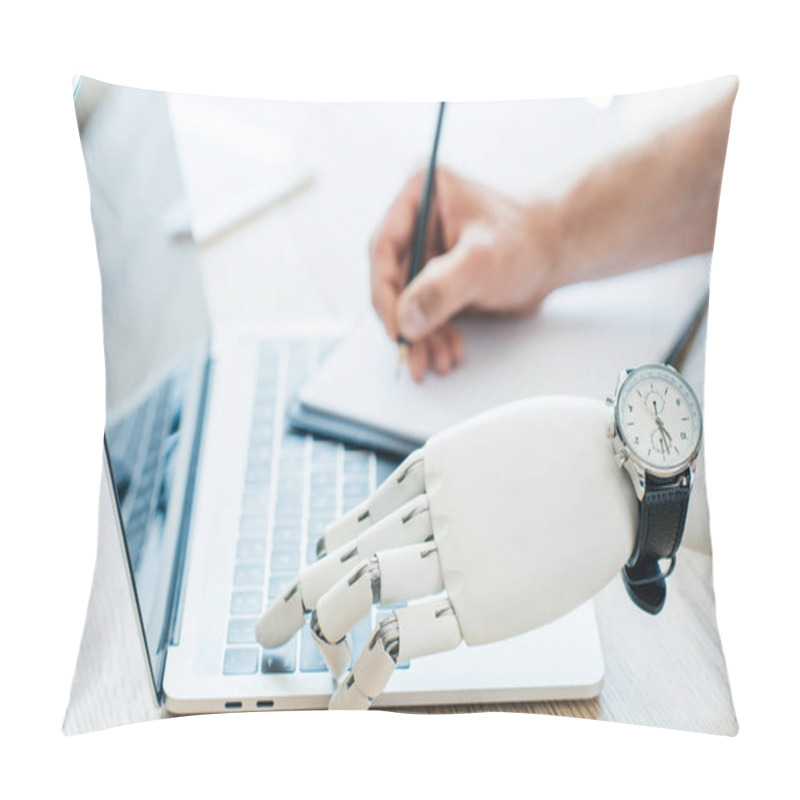 Personality  Close-up View Of Robotic Arm With Wristwatch Using Laptop And Human Hand Taking Notes At Wooden Table   Pillow Covers