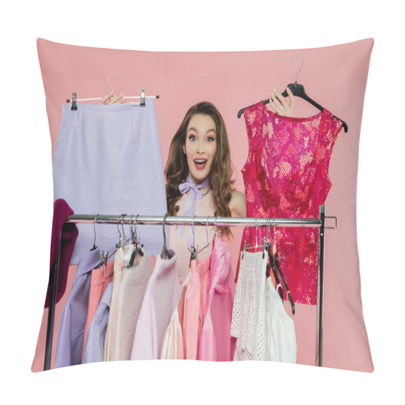 Personality  Consumerism, Amazed Young Woman With Brunette Wavy Hair Standing Near Rack With Clothes, Showing Trendy Outfit, Wardrobe Selection Concept, Beautiful Model Looking At Camera On Pink Background  Pillow Covers