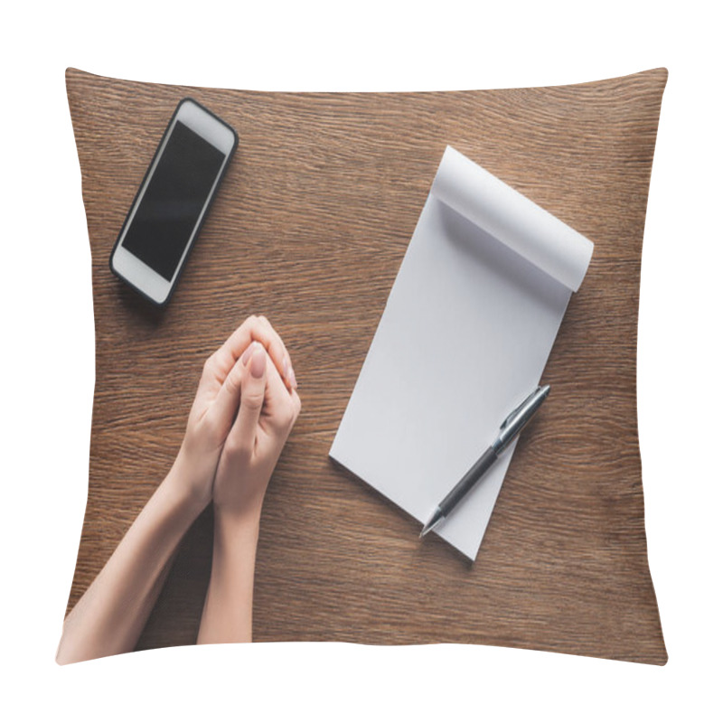 Personality  Cropped View Of Person With Folded Hands, Pen, Notebook With Copy Space And Smartphone With Blank Screen On Wooden Background Pillow Covers