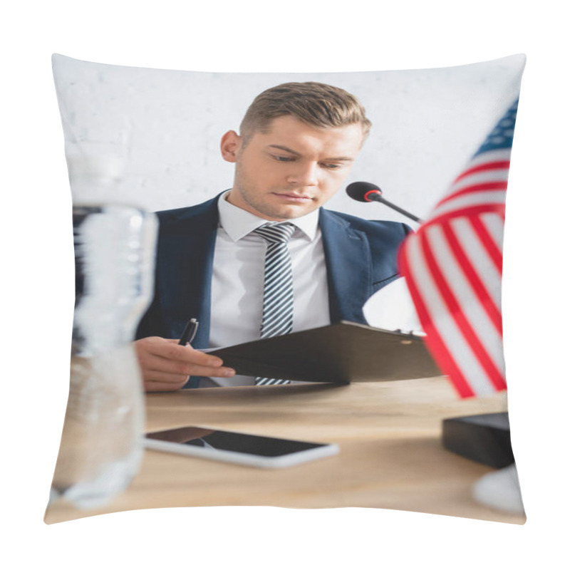 Personality  Serious Politician Holding And Looking At Clipboard, While Sitting At Table With Microphone On Blurred Foreground Pillow Covers