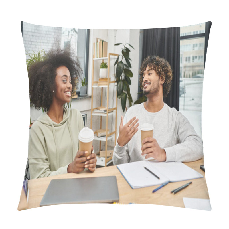 Personality  A Man And A Woman From Different Cultures Engage In Conversation While Sitting At A Table In A Modern Coworking Space. Pillow Covers