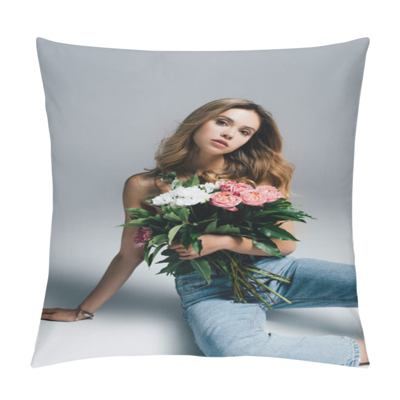 Personality  Sexy Young Woman In Jeans Looking At Camera While Sitting With Flowers On Grey Pillow Covers