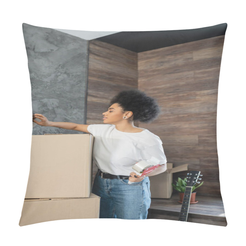 Personality  Side View Of African American Woman Holding Adhesive Tape Near Carton Boxes During Moving Pillow Covers