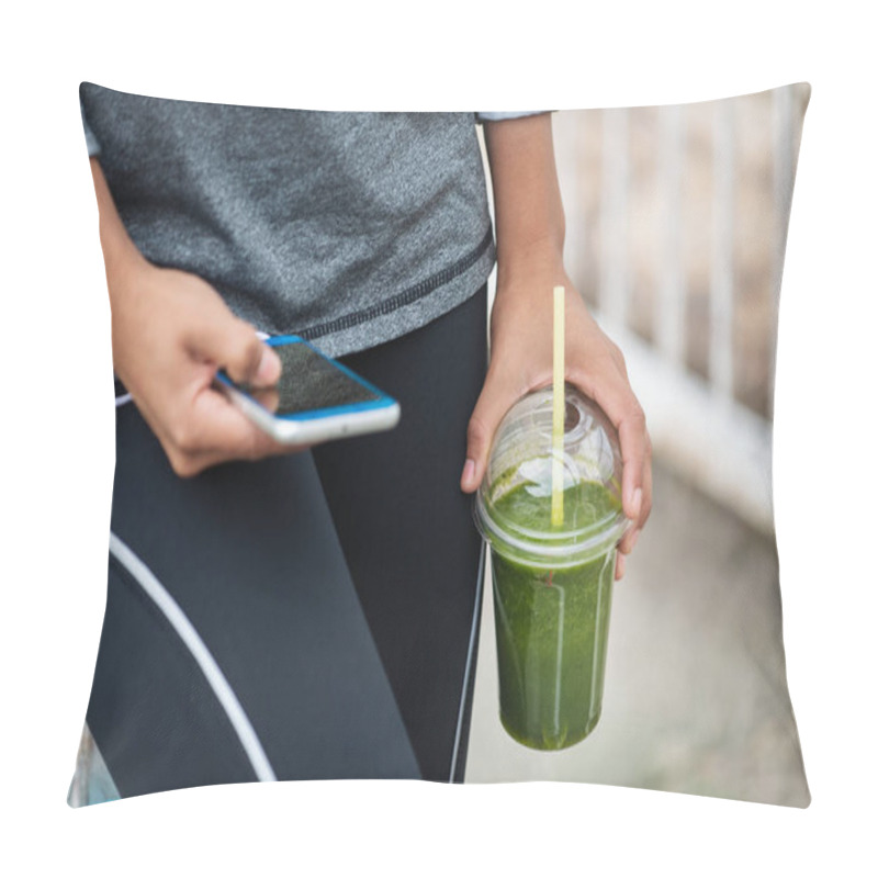 Personality  Detail Of Woman Holding Green Detox Smoothie And Smartphone While Taking A Workout Rest. Urban Fitness Lifestyle And Healthy Nutrition Concept. Pillow Covers