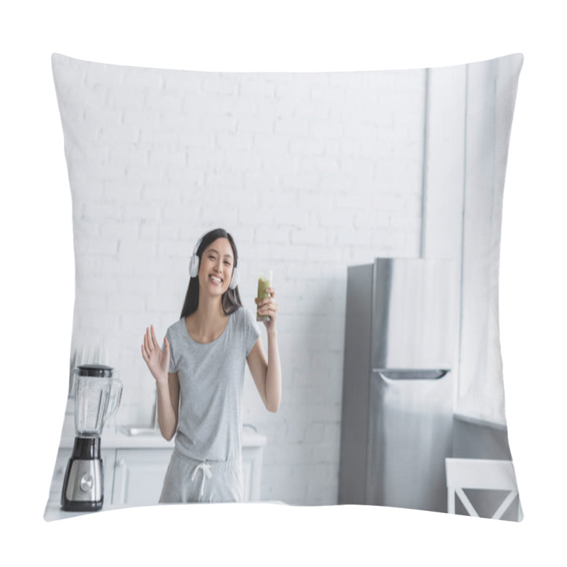 Personality  Happy Asian Woman In Headphones Holding Glass Of Smoothie And Waving Hand At Camera Near Electric Shaker Pillow Covers