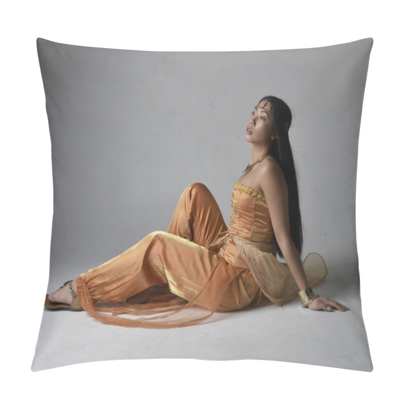 Personality  Full Length Portrait Of Pretty Young Asian Woman Wearing Golden Arabian Robes Like A Genie, Seated Pose, Isolated On Studio Background. Pillow Covers