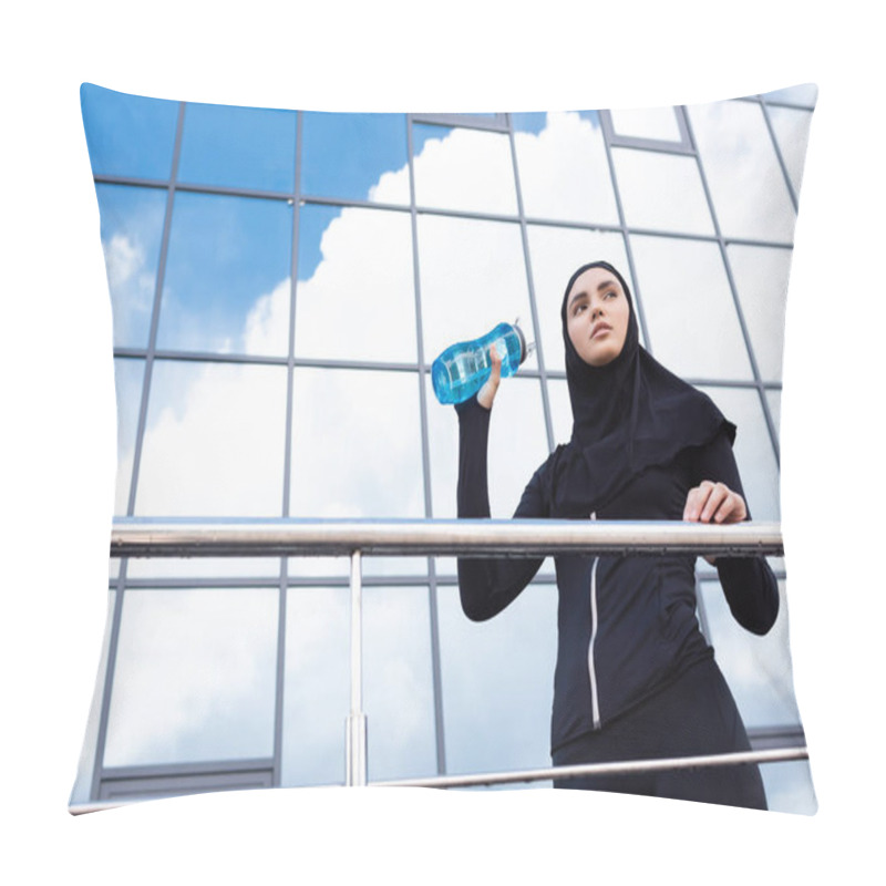 Personality  Low Angle View Of Young Muslim Woman In Hijab Holding Sports Bottle Near Modern Building  Pillow Covers