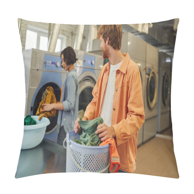 Personality  Smiling Man Sorting Clothes Near Basket And Asian Girlfriend In Blurred Public Laundry Pillow Covers