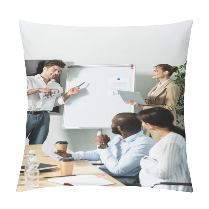 Personality  Smiling Businessman With Newspaper Pointing At Flip Chart Near Multiethnic Colleagues Pillow Covers