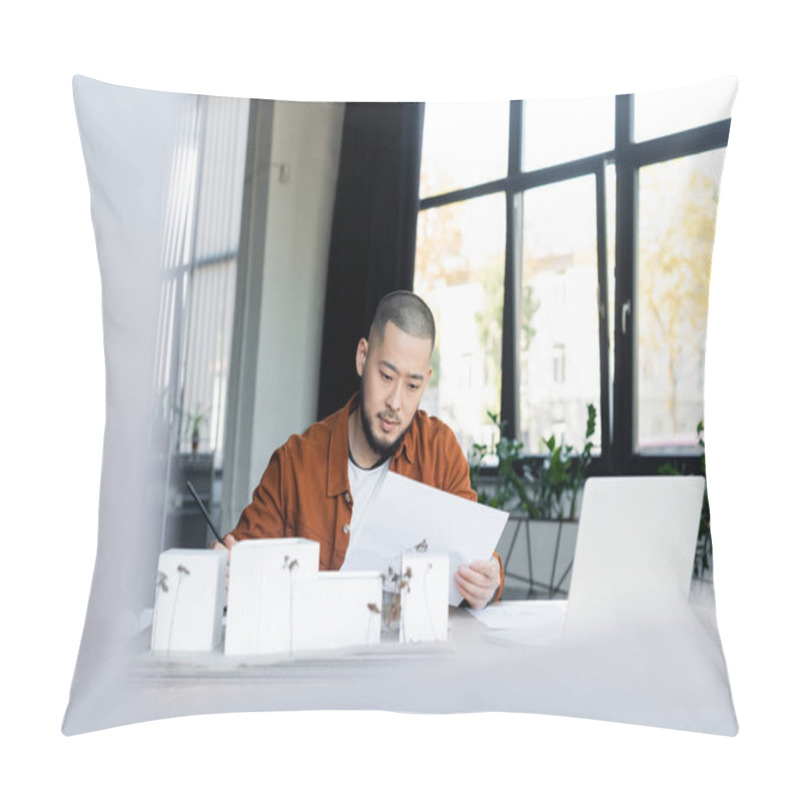 Personality  Asian Architect Looking At Document While Working Near Blurred Laptop And House Models Pillow Covers