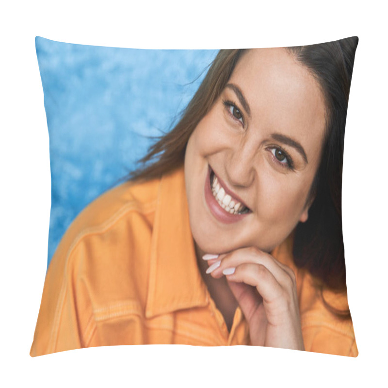 Personality  Portrait Of Joyous Plus Size Woman With Brunette Hair And Natural Makeup Wearing Orange Jacket And Touching Face While Posing And Looking At Camera On Mottled Blue Background, Body Positive  Pillow Covers