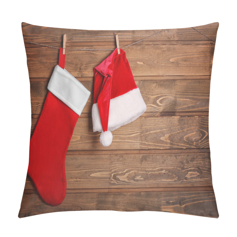 Personality  Christmas Stocking And Santa Claus Hat Hanging Against Wooden Background Pillow Covers