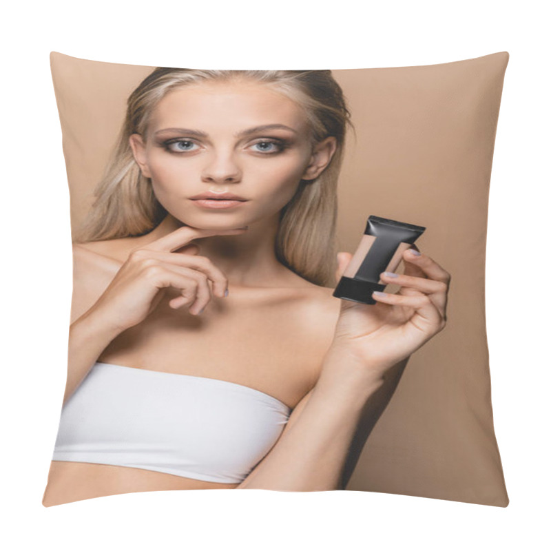 Personality  Young Woman With Perfect Skin Holding Face Foundation While Touching Chin Isolated On Beige Pillow Covers