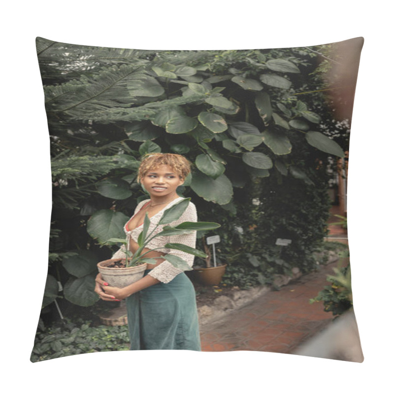 Personality  Positive And Trendy African American Woman In Summer Outfit In Knitted Top And Skirt Holding Potted Plant And Looking Away While Standing In Indoor Garden, Stylish Lady Surrounded By Lush Greenery Pillow Covers