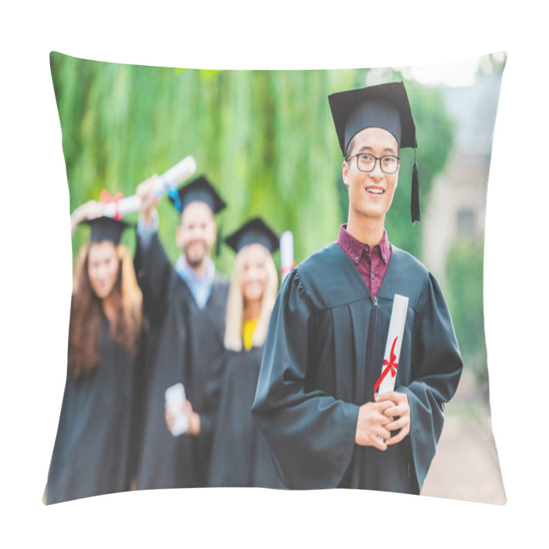 Personality  Selective Focus Of Smiling Asian Graduate With Classmates Behind In Summer Park Pillow Covers