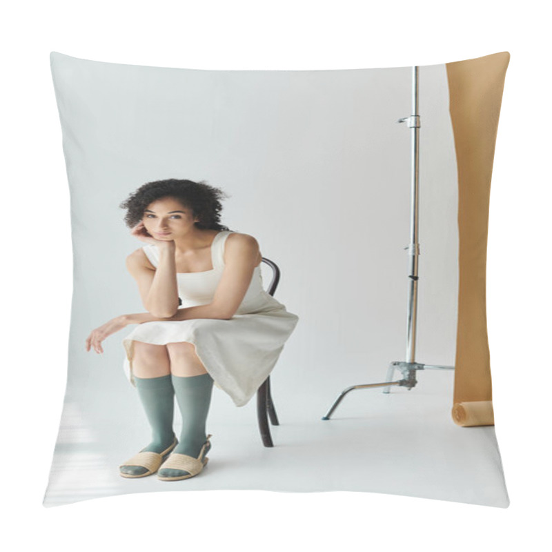 Personality  A Fashionable Woman Sits Thoughtfully On A Chair, Showcasing Her Chic Outfit In Soft Light. Pillow Covers