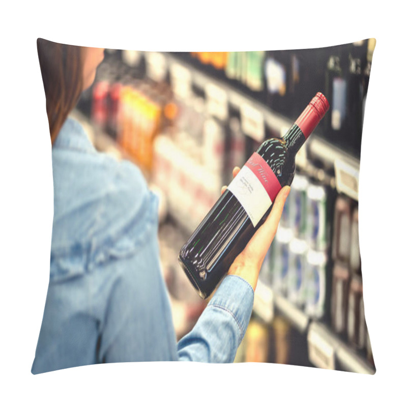 Personality  Woman Reading The Label Of Red Wine Bottle In Liquor Store Or Alcohol Section Of Supermarket. Shelf Full Of Alcoholic Beverages. Female Customer Holding And Choosing A Bottle Of Merlot Or Sangiovese. Pillow Covers