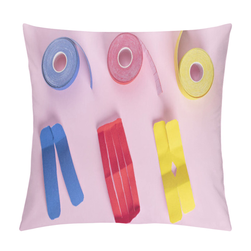 Personality  Rolls Kinesiology Tape In Shape Of Lantern, Letters X And V For Lymphatic Drainage Taping On Pink Background. Flat Lay, View From Above Pillow Covers