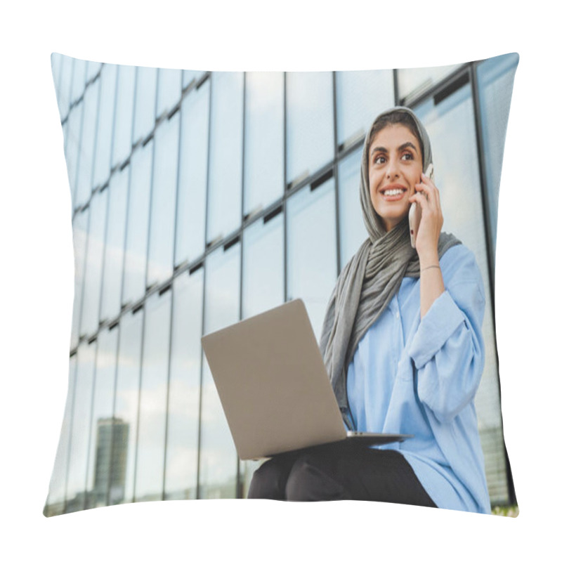 Personality  Cheerful Middle-aged Muslim Woman Wearing Hijab Talking On Cellphone And Using Laptop While Sitting Outdoors At City Street Pillow Covers