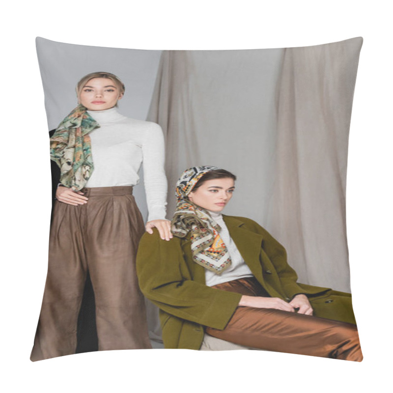 Personality  Woman In Kerchief Looking At Camera Near Elegant Friend Sitting On Grey Background With Drapery Pillow Covers