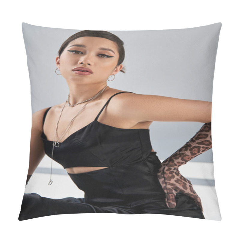 Personality  Trendy Spring, Portrait Of Sensual Asian Woman With Expressive Gaze And Bright Makeup, In Black Strap Dress And Silver Accessories, Holding Hand On Hip On Grey Background With Lighting And Shadows Pillow Covers