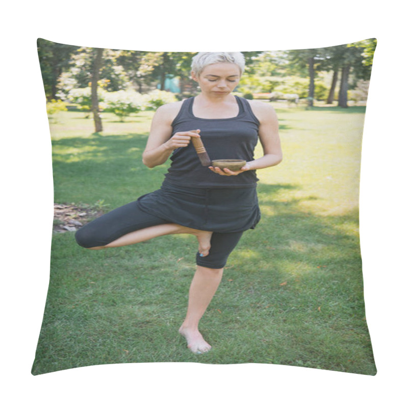 Personality  Woman Practicing Yoga In Tree Pose And Making Sound With Tibetan Singing Bowl In Park  Pillow Covers