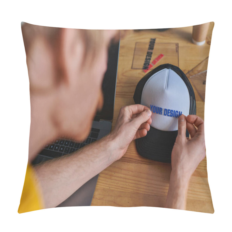 Personality  Blurred Young Designer Holding Printing Layer Near Snapback While Working On Project Near Laptop On Table In Print Studio, Hands-on Entrepreneurship Concept, Your Design Letters  Pillow Covers