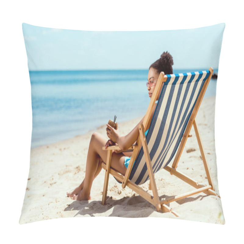 Personality  African American Woman In Bikini And Sunglasses Holding Cocktail In Coconut Shell While Sitting On Deck Chair In Front Of Sea  Pillow Covers