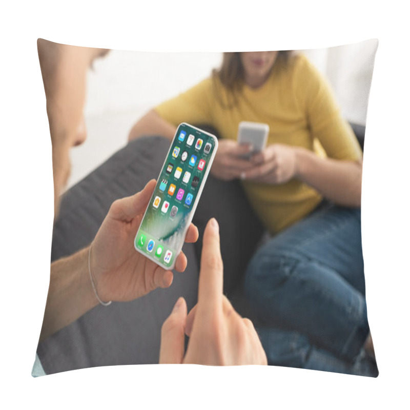 Personality  KYIV, UKRAINE - FEBRUARY 21, 2020: Selective Focus Of Man Holding Smartphone With Iphone Screen Near Woman On Couch  Pillow Covers