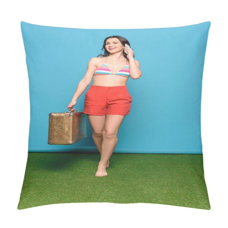 Personality  Happy Young Woman In Shorts And Swimsuit Bra Talking On Smartphone While Holding Vintage Suitcase On Blue Background Pillow Covers