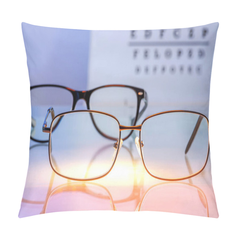 Personality  Eyeglasses With Prescription Lenses On A Backlit Glass Table Against A Visual Test With Letters In Blur Background. Vision Correction And Ophthalmology Concept. Selected Focus Pillow Covers