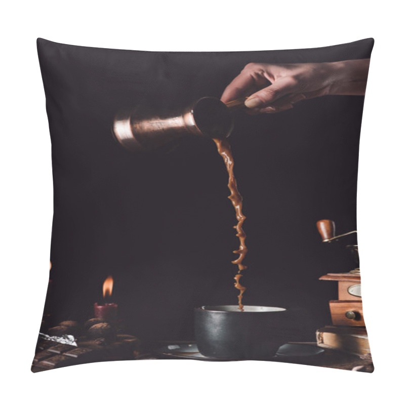 Personality  Cropped Shot Of Woman Pouring Coffee From Turk Into Cup At Table With Chocolate, Truffles, Candles And Coffee Grains On Black Background Pillow Covers