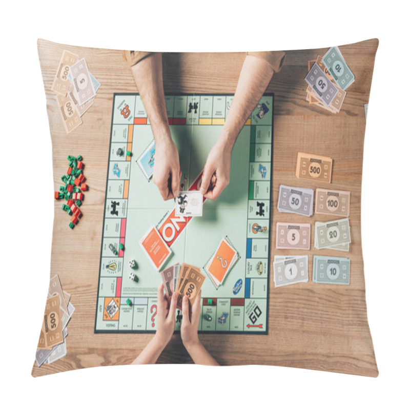 Personality  KYIV, UKRAINE - NOVEMBER 15, 2019: Cropped View Of Man Holding Explanation Card And Woman With Toy Currency While Playing In Monopoly Game Pillow Covers