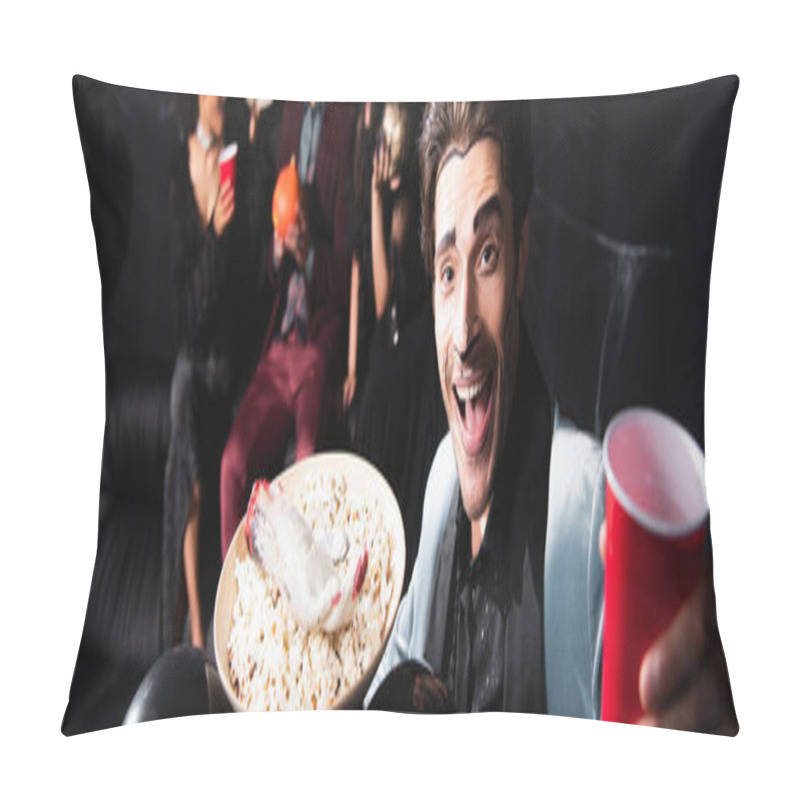 Personality  Cheerful Man With Halloween Makeup Holding Bowl With Popcorn And Toy Hand Near Blurred Friends On Black Background, Banner Pillow Covers