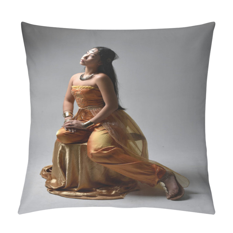 Personality  Full Length Portrait Of Pretty Young Asian Woman Wearing Golden Arabian Robes Like A Genie, Seated Pose, Isolated On Studio Background. Pillow Covers