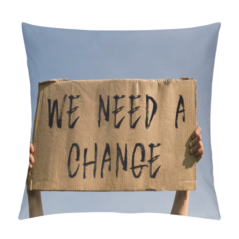 Personality  A Poster With The Words WE NEED A CHANGE In The Hands Of A Young Girl Against A Blue Sky. Pillow Covers