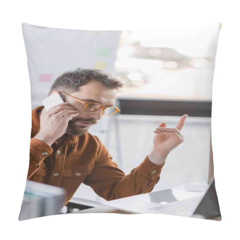 Personality  Focused Bearded Businessman In Eyeglasses And Shirt Talking On Smartphone And Showing Attention Gesture Near Laptop And Blurred Notebooks At Workplace In Office Pillow Covers