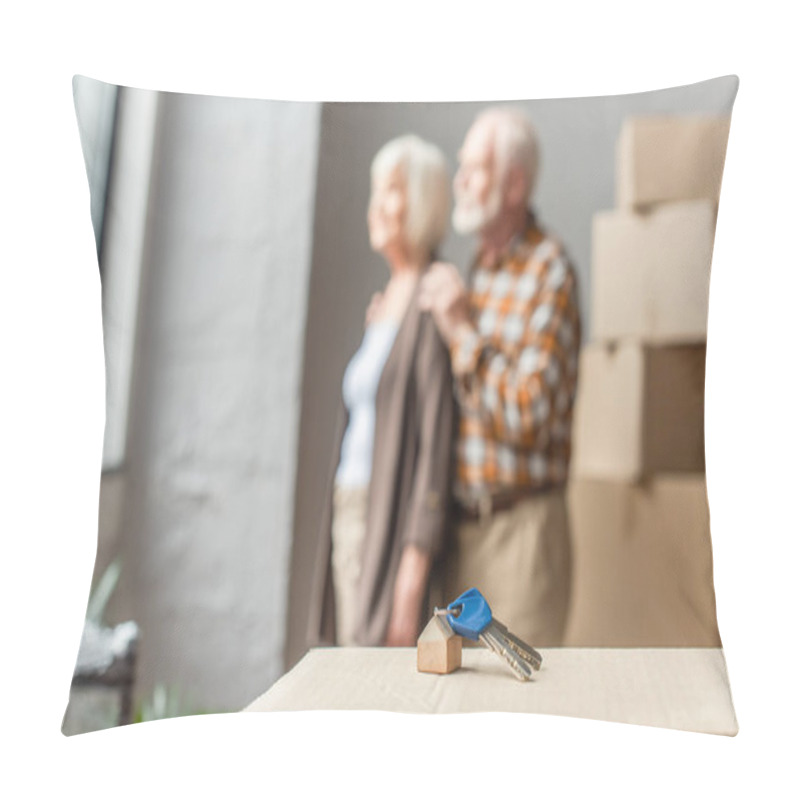 Personality  Blurred View Of Senior Couple Moving Into New House And Keys On Foreground Pillow Covers