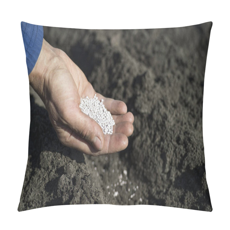 Personality  The Hand Of A Woman Farmer Holding A Handful Of White Fertilizer Granules On The Background Of An Earth Bed. Pillow Covers