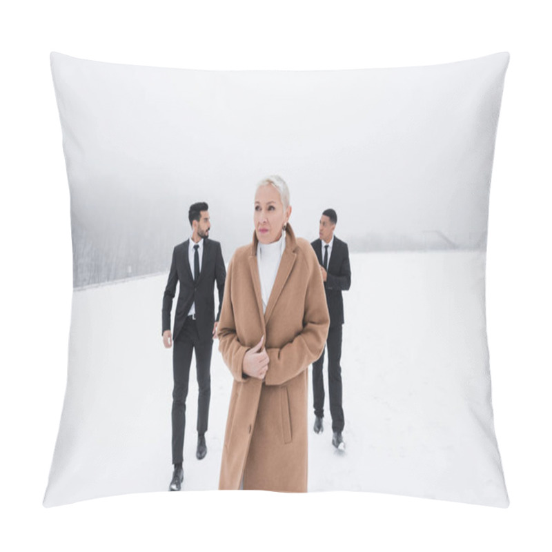 Personality  Senior Businesswoman In Coat Walking Across Winter Field Near Multiethnic Bodyguards In Suits Pillow Covers