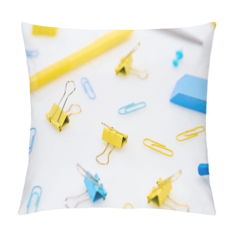 Personality  Selective Focus Of Yellow And Blue Paper Clips With Pen, Eraser, Scissors And Pencil Sharpener On White Background Pillow Covers