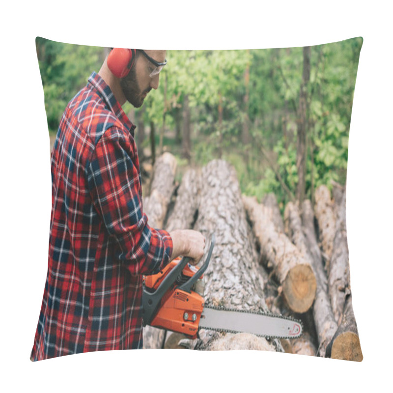 Personality  Concentrated Lumberer In Earmuffs And Protective Glasses Cutting Wood With Chainsaw In Forest Pillow Covers