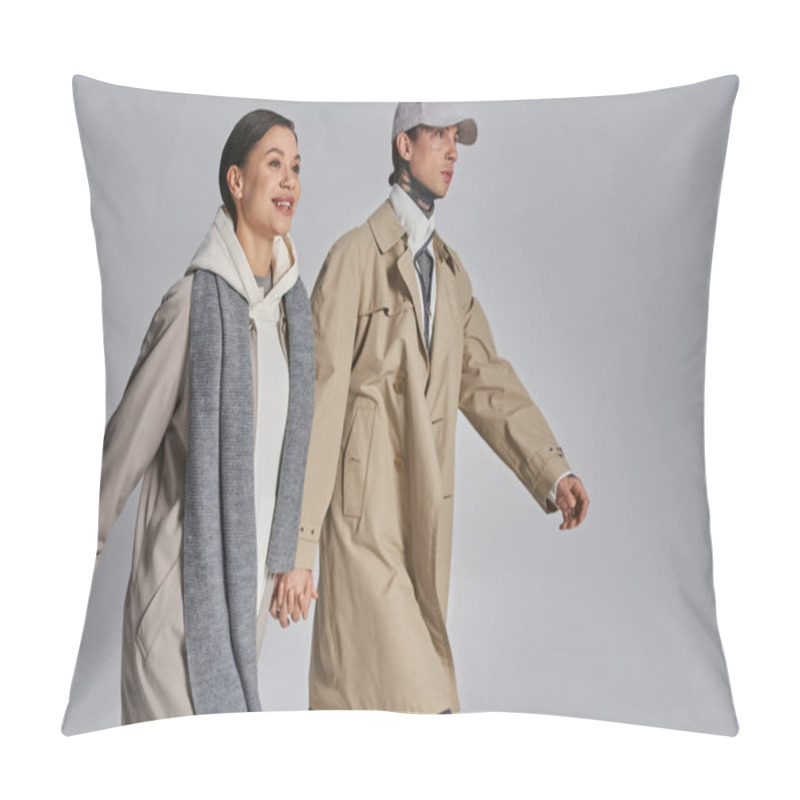 Personality  Young Stylish Couple In Trench Coats Walking Together In A Studio Against A Grey Background. Pillow Covers