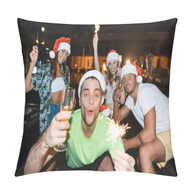 Personality  Selective Focus Of Man In Santa Hat Holding Sparkler And Glass Of Champagne Near Friends During Party At Night  Pillow Covers