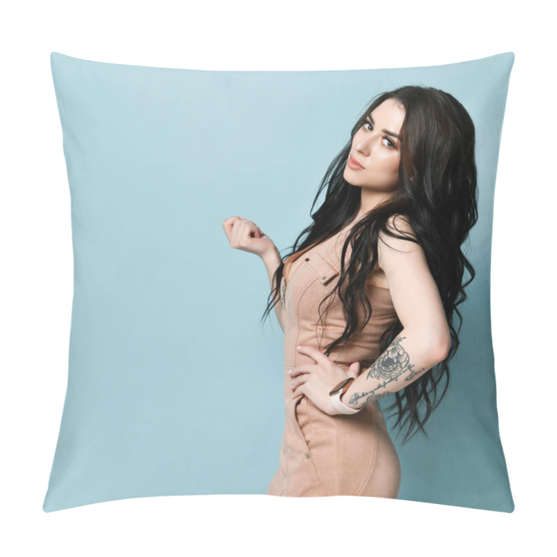 Personality  Brunette Model In Beige Dress. There Is Watch On Her Tattooed Hand. Standing Sideways Against Blue Studio Background. Close Up Pillow Covers