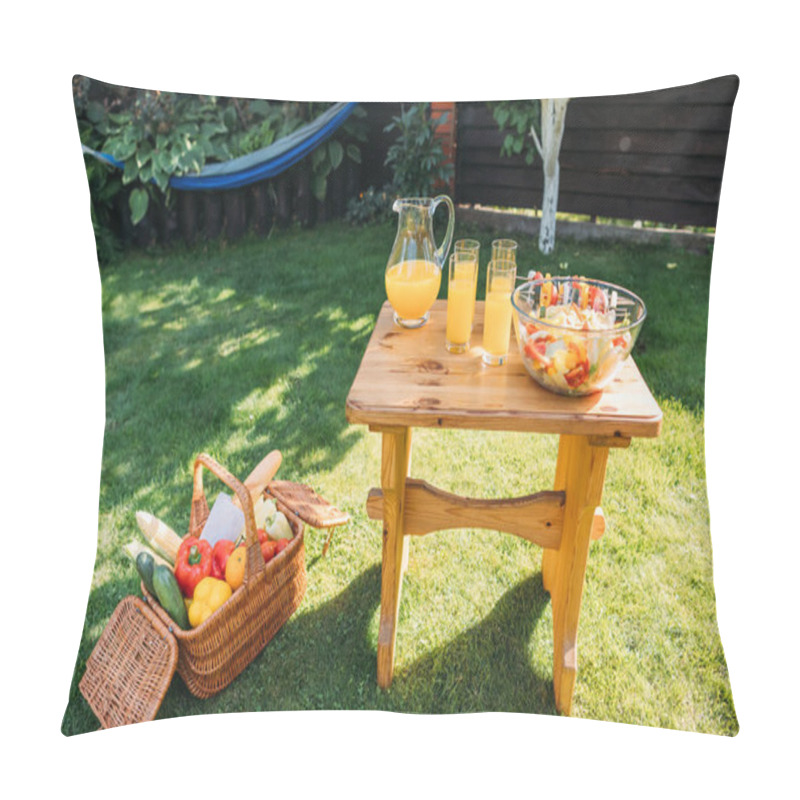 Personality  Close Up View Of Basket With Food For Picnic, Glasses Of  Juice And Fresh Salad On Wooden Chair On Green Lawn Pillow Covers