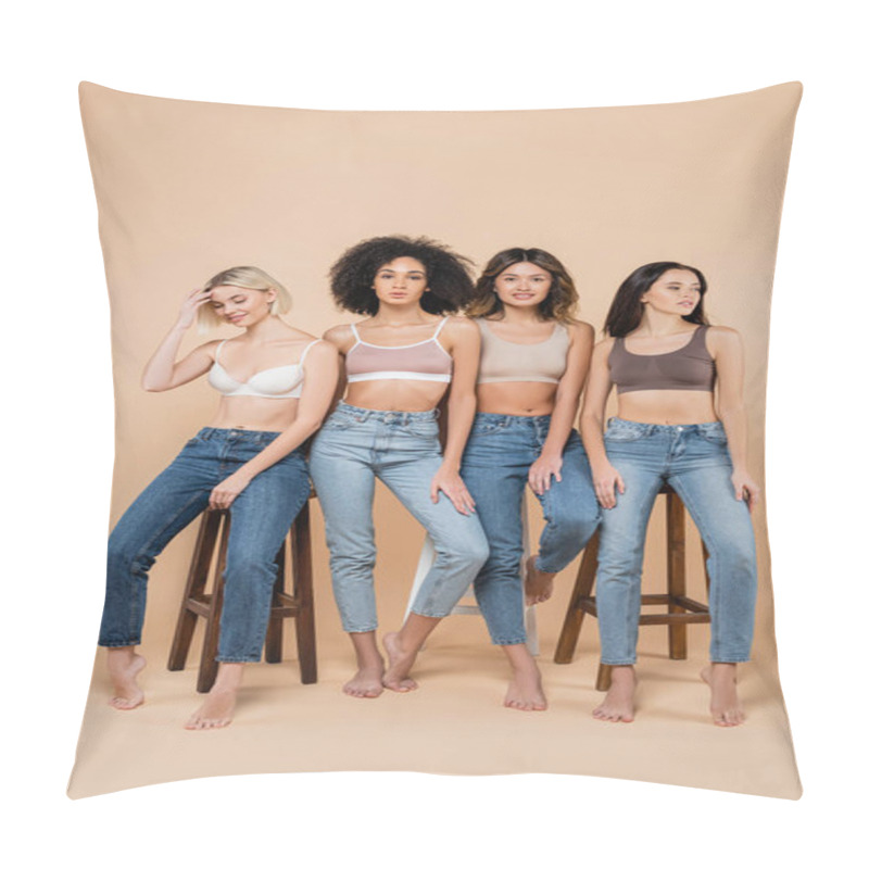 Personality  Slim Interracial Women In Bras And Jeans Posing Near High Stools On Beige Pillow Covers